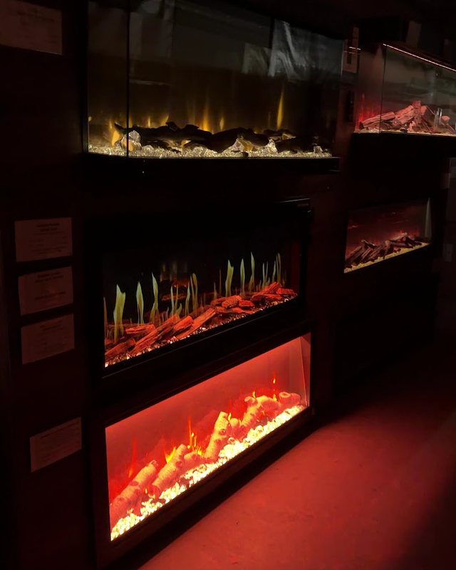 Fireplaces lit along the showroom wall